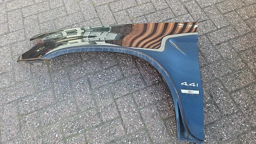 Voorscherm spatbord linksvoor BMW X5 serie E53 kleur Cosmos zwart 303 41357000385 7000385