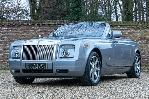 Rolls-Royce Phantom Drophead Coupé "One of the finest" Livery in "Jubilee Silver" with Black/Creme Light leather and Piano Black veneer, Low mileage Phantom DHC in pristine condition,Extremely well-maintained European spec car, "A spirit-lifting motorcar dedicated to delivering the essentials of pleasure", History documented in books and invoices,The ultimate colour combination with the beloved chrome exhaust tips,